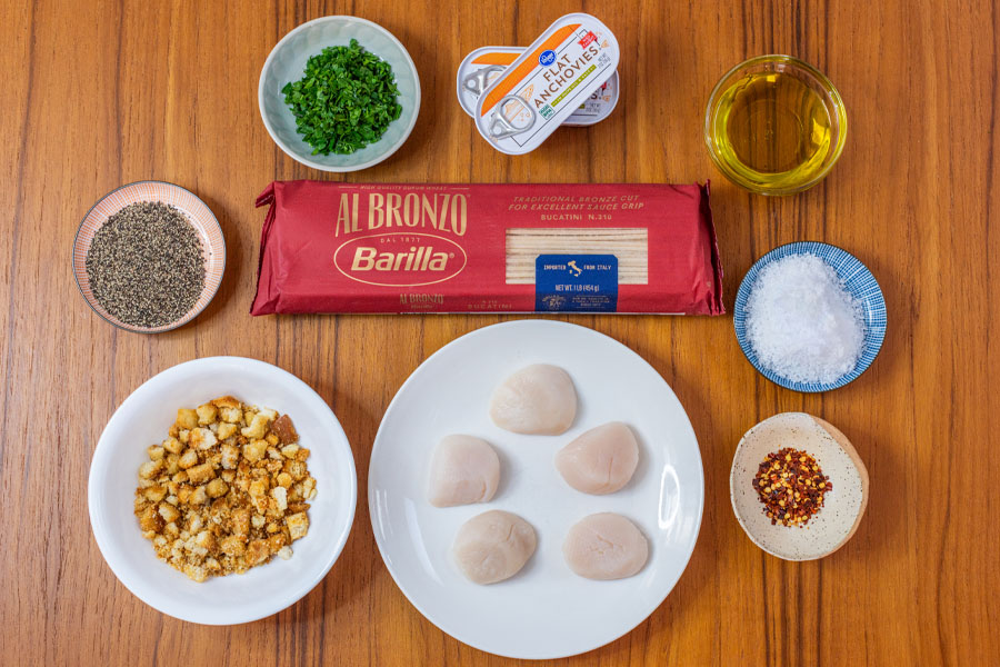 Ingredients for Scallops alla Siciliana including Lighthouse Seafoods sea scallops, spaghetti, anchovies, olive oil and breadcrumbs for the Lighthouse Seafoods recipe.