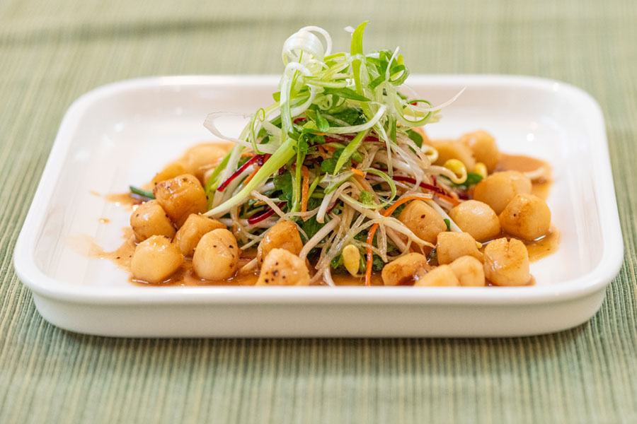 Lighthouse Seafoods seared bay scallop salad with shredded vegetables and savory dressing.