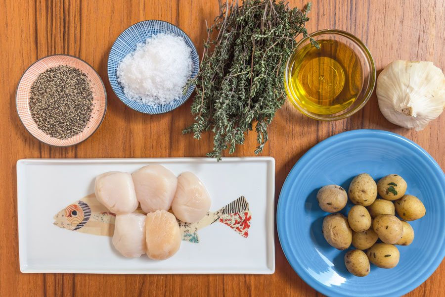 Ingredients for Lighthouse Seafoods seared sea scallops with crispy smashed potatoes including fresh sea scallops, baby potatoes, garlic, thyme, olive oil, salt and pepper.